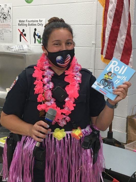 Officer Jen at Ocean Breeze Elementary presenting a Book Club Award